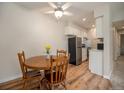 Cozy dining area with wooden table and chairs, adjacent to the kitchen with stainless steel appliances at 309 E Highline Cir # 104, Centennial, CO 80122