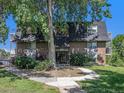 Charming brick apartment building with well-maintained landscaping and mature trees at 309 E Highline Cir # 104, Centennial, CO 80122
