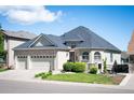 Lovely two-story home with a three car garage and manicured front yard at 7007 S Garrison St, Littleton, CO 80128