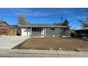 A well-kept single story home with neutral colored brick, freshly poured driveway and updated landscaping at 121 Joan Dr, Denver, CO 80221