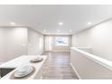 Bright, open living area with modern floors and a large window letting in plenty of natural light at 121 Joan Dr, Denver, CO 80221