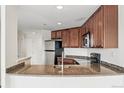 Granite counter overlooks stainless steel sink and modern appliances at 100 Park Ave # 907, Denver, CO 80205