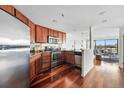 Well-equipped kitchen with stainless steel appliances and wood cabinets with an open concept at 100 Park Ave # 907, Denver, CO 80205
