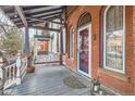 Inviting front porch featuring a porch swing, arched windows, and a red-accented front door at 1229 Josephine St, Denver, CO 80206