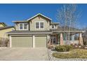 Inviting two-story home with a two-car garage, covered porch, and lovely landscaping enhancing its curb appeal at 10726 Amesbury Way, Highlands Ranch, CO 80126