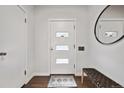 Bright foyer features a stylish rug, a modern bench, and a sleek mirror at 2835 N Monaco Pkwy, Denver, CO 80207