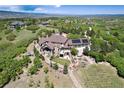 Stunning aerial view of a luxury home with mature landscaping and mountain views at 2916 Hiwall Ct, Castle Rock, CO 80109