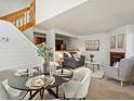 Cozy living room with fireplace open to dining area, creating a warm and inviting atmosphere at 277 S Taft Ct # 54, Louisville, CO 80027