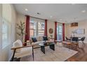 Bright living room featuring modern furniture, large windows, and a cozy seating area for relaxation at 2936 Iola St, Denver, CO 80238