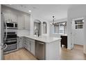 Bright kitchen featuring stainless steel appliances, modern fixtures and a sleek island at 1409 Carlyle Park Cir, Highlands Ranch, CO 80129