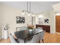 Elegant dining room with modern light fixture, stylish decor, and warm ambiance for gatherings at 6274 S Iola Ct, Englewood, CO 80111