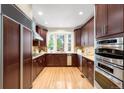 Gourmet kitchen featuring custom cabinets, granite countertops, and stainless steel appliances, perfect for cooking at 6274 S Iola Ct, Englewood, CO 80111