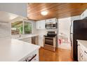 Bright kitchen with stainless steel appliances and a view into an adjacent eating area at 3756 S Mission Pkwy, Aurora, CO 80013