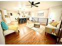 Inviting open-concept living space featuring wood floors, modern furnishings, and natural light at 1853 S Urban Way, Lakewood, CO 80228