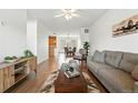 Open floor plan with hardwood floors, and seamlessly connected to a dining area and kitchen for modern living at 5574 W 72Nd Dr, Arvada, CO 80003