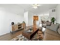 Open floor plan with hardwood floors, and seamlessly connected to a dining area and kitchen for modern living at 5574 W 72Nd Dr, Arvada, CO 80003