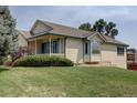 Exterior view of a single-story home with a well-manicured lawn and mature trees at 9784 W Euclid Dr, Littleton, CO 80123