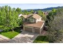 Beautiful two-story home with a stone facade, two-car garage, and well-manicured front lawn at 9162 W Unser Ave, Littleton, CO 80128
