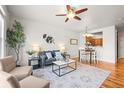 Inviting living room featuring wood floors, stylish decor, and an open layout at 17026 River Birch Pt, Monument, CO 80132