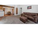 Open-concept living space with a dining area, exposed wood beams and comfortable seating at 11905 E Harvard Ave # 208, Aurora, CO 80014