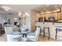 Open-concept dining area with modern chandelier, adjacent to the kitchen and living spaces at 4137 Clifton Ct, Boulder, CO 80301