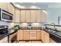 Modern kitchen featuring light wood cabinets, granite countertops, and stainless steel appliances at 4137 Clifton Ct, Boulder, CO 80301