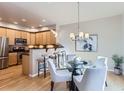 Eat-in kitchen with light wood cabinets, stainless steel appliances, and a breakfast bar at 4137 Clifton Ct, Boulder, CO 80301