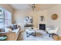 Cozy living room showcasing a fireplace, large window, and stylish furnishings at 4137 Clifton Ct, Boulder, CO 80301