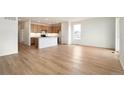 Bright living room with an open floor plan and a spacious kitchen area at 11124 Xanadu St, Commerce City, CO 80022