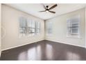 Bright bedroom with gleaming hardwood floors and three large windows offering plenty of natural light at 14176 Jackson St, Thornton, CO 80602