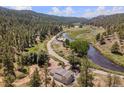 Scenic aerial view of a property nestled in a lush, mountainous landscape with a winding river at 2230 S Platte River Rd, Sedalia, CO 80135