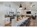 Modern kitchen featuring white cabinetry, stainless steel appliances, and a stylish island with seating at 2230 S Platte River Rd, Sedalia, CO 80135