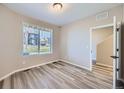Cozy bedroom with wood-style flooring and a window at 9627 Browns Peak Cir, Littleton, CO 80125