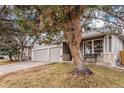 Two-story home featuring a two-car garage, inviting front porch, and beautifully landscaped yard at 13421 Humboldt Way, Thornton, CO 80241