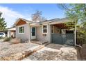 Inviting exterior showcasing a well-maintained facade, private gated carport, and xeriscaped front yard at 3368 S Corona St, Englewood, CO 80113