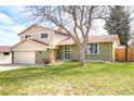 Charming two-story home boasts a manicured front lawn and a combination brick and siding exterior at 3408 S Kittredge St, Aurora, CO 80013