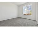 Bright, carpeted bedroom with large window and ample natural light at 25204 E Warren Pl, Aurora, CO 80018