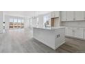 Open-concept kitchen featuring a center island, sleek countertops, and ample cabinet space at 25204 E Warren Pl, Aurora, CO 80018