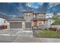 Charming two-story home featuring a three-car garage and inviting front porch at 2775 Morningbird Ln, Castle Rock, CO 80109