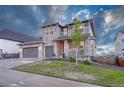 Stylish two-story home with a three-car garage and well-manicured front lawn at 2775 Morningbird Ln, Castle Rock, CO 80109