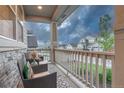 Cozy front porch seating area with chairs and serene neighborhood views at 2775 Morningbird Ln, Castle Rock, CO 80109