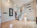 Bright living room features vaulted ceiling, hardwood floors and a view of the second-floor landing at 5163 Apache Creek Rd, Castle Rock, CO 80109