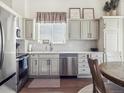 Well-lit kitchen featuring stainless steel appliances, modern cabinetry, and sleek countertops at 10657 Cherrybrook Cir, Highlands Ranch, CO 80126