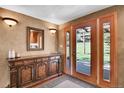Inviting entryway featuring a wooden door with sidelights and beautiful wood accents at 29551 Dorothy Rd, Evergreen, CO 80439