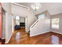 Bright entryway with hardwood floors, staircase, and views to living room at 1626 Adobe Pl, Highlands Ranch, CO 80126