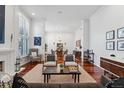 Bright living room with hardwood floors, fireplace, high ceilings, and open layout at 4032 S Olive St, Denver, CO 80237