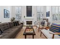 Bright and airy living room with a cozy fireplace and large windows offering plenty of natural light at 4032 S Olive St, Denver, CO 80237