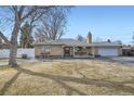 Beautiful single-story home with a classic brick facade and well-manicured front lawn at 4585 Garrison St, Wheat Ridge, CO 80033