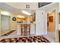 Open kitchen area with bar seating and modern appliances, adjacent to the living space at 6001 S Yosemite St # B203, Greenwood Village, CO 80111