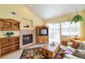 Cozy living room with a fireplace, wooden furniture, and sliding door to a patio at 6001 S Yosemite St # B203, Greenwood Village, CO 80111